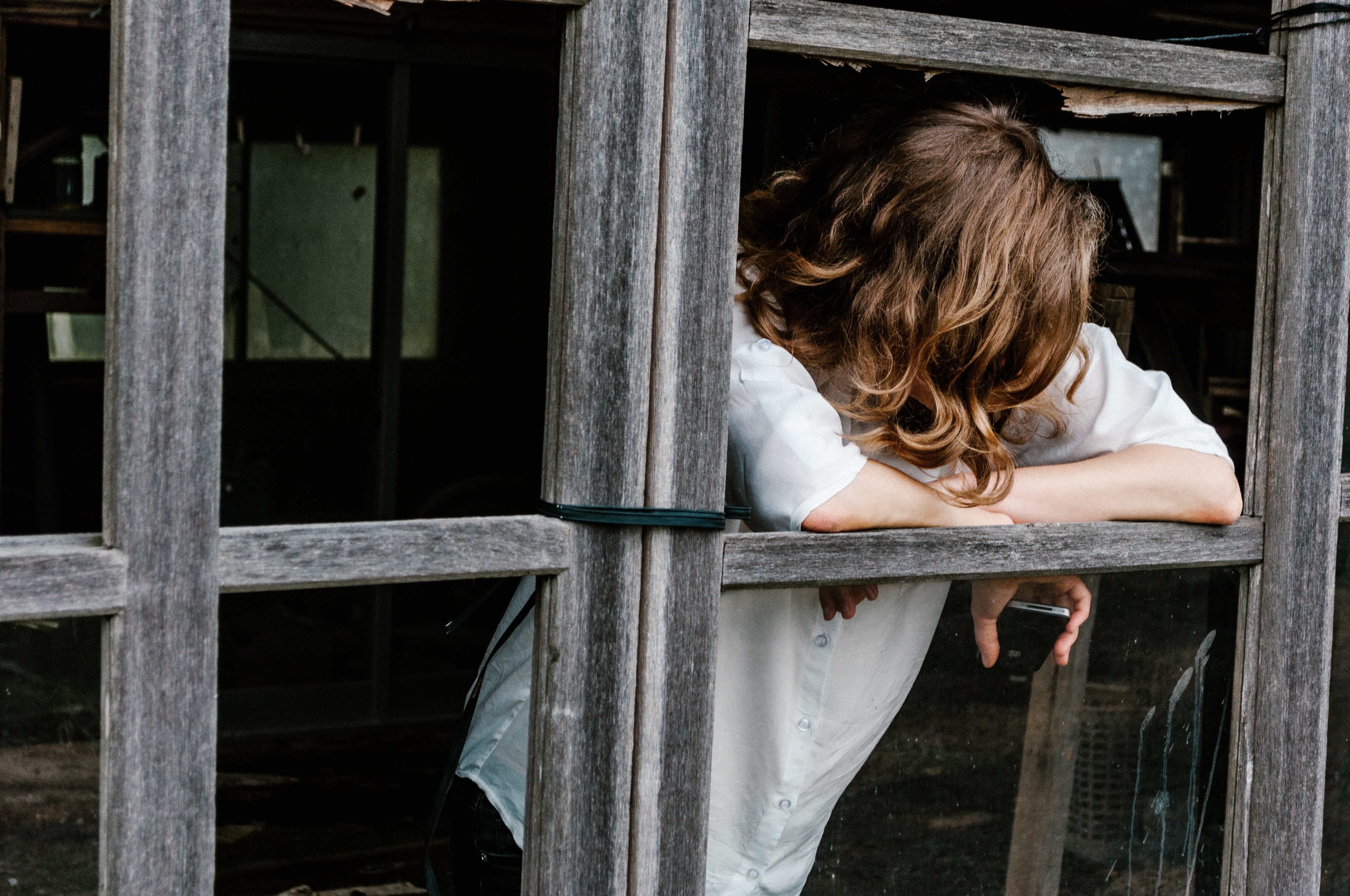 young woman leaning out of a window